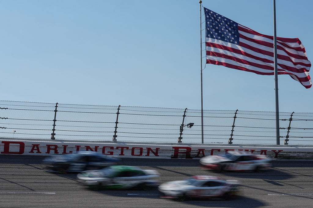 A pack of cars compete through Turn 3 during a NASCAR Cup Series auto race, Sunday, March 22, 2026, in Darlington, S.C.(AP Photo/Matt Kelley)