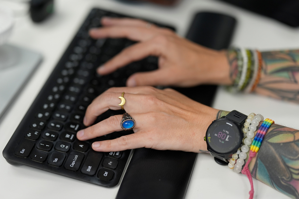 Deanna Danger types an AI prompt into her computer as she uses the technology to assist in her tasks as an administrative assistant at Vanderbilt University, Thursday, June 11, 2026, in Nashville, Tenn. (AP Photo/George Walker IV)