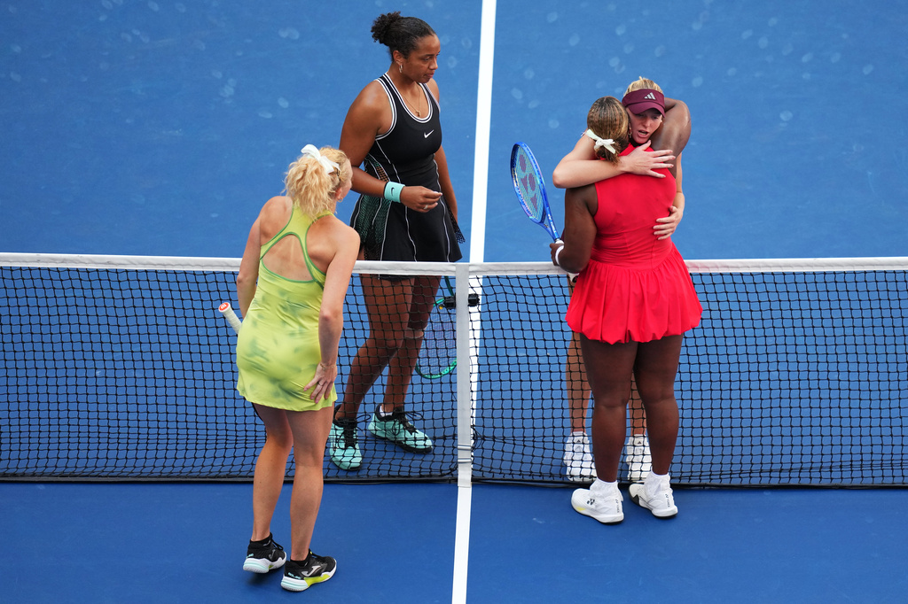 Katerina Siniakova, of the Czech Republic, bottom left, and Taylor Townsend, of the United States, bottom right, meet Robin Montgomery, of the United States, top left, and Ashlyn Krueger, of the United States, top right, at the net after Siniakova and Townsend won the women's doubles final of the U.S. Open tennis championships, Friday, Sept. 11, 2026, in New York. (AP Photo/Kirsty Wigglesworth)