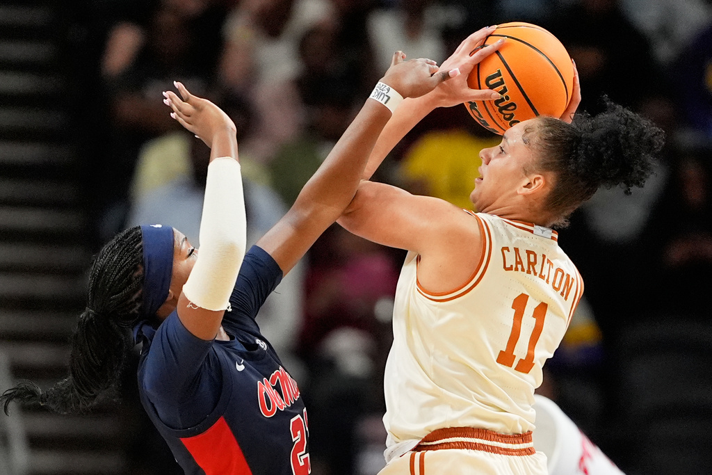 Texas forward Justice Carlton shoots over Mississippi guard Debreasha Powe during the first half of an NCAA college basketball game in the semifinals of the Southeastern Conference tournament, Saturday, March 7, 2026, in Greenville, S.C. (AP Photo/Chris Carlson)