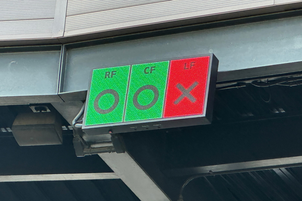In this photo taken with a smartphone, a video board above home plate at Salt River Fields shows outfielders if they are in the correct Thursday, Oct. 22, 2026, in Scottsdale, Ariz. (AP Photo/David Brandt)