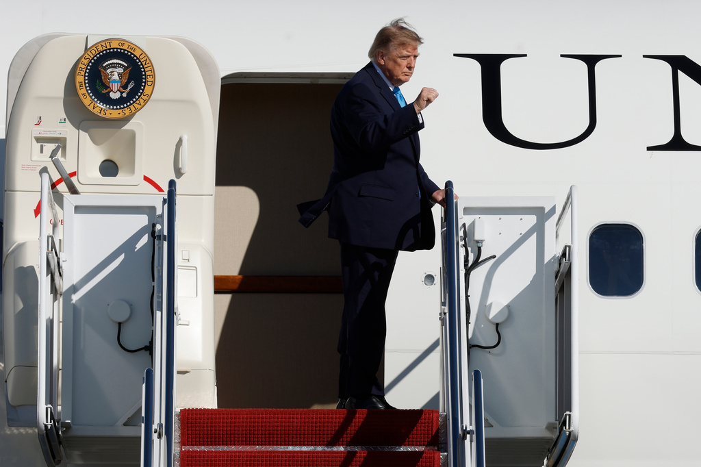 President Donald Trump gestures from the stairs of Air Force One upon his departure at Joint Base Andrews, Md., Monday, Oct. 5, 2026. (AP Photo/Luis M. Alvarez)