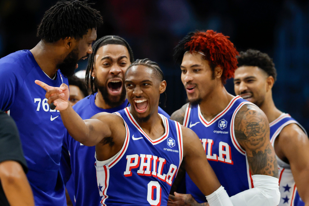 Philadelphia 76ers guard Tyrese Maxey (0) celebrates with his teammates after scoring against the Charlotte Hornets during the second half of an NBA basketball game in Charlotte, N.C., Saturday, March 28, 2026. (AP Photo/Nell Redmond)