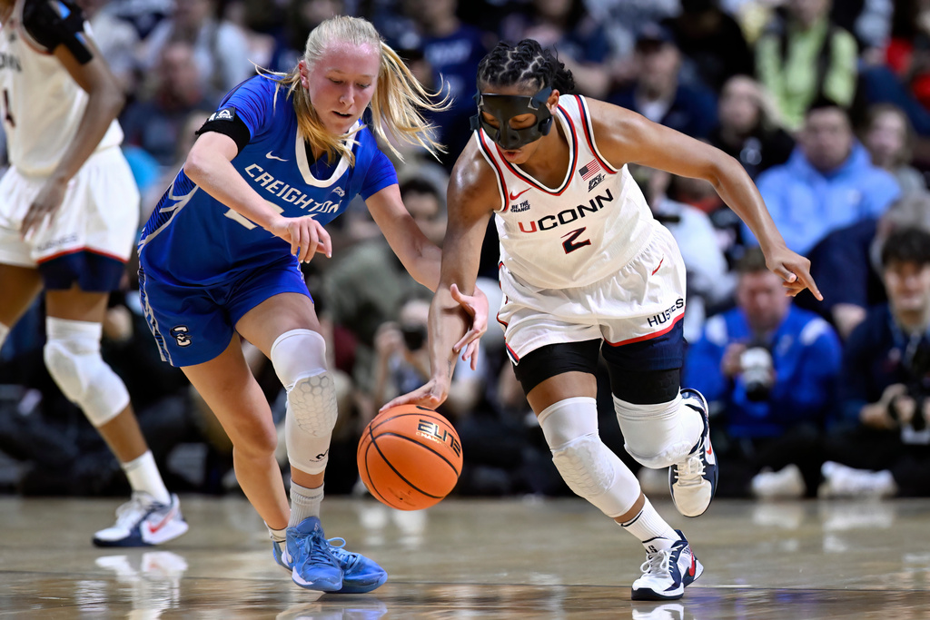 UConn guard KK Arnold, right, steals the ball from Creighton guard Ava Zediker during first half of an NCAA college basketball game in the semifinals of the Big East tournament, Sunday, March 8, 2026, in Uncasville, Conn. (AP Photo/Jessica Hill)