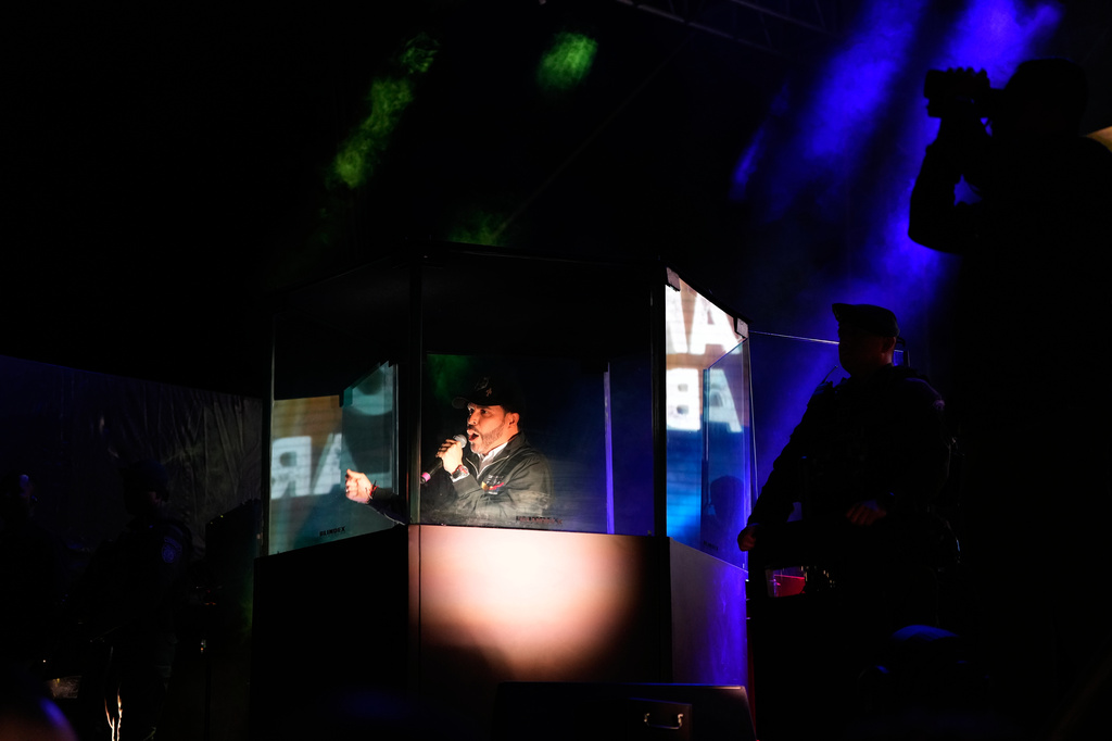 FILE- Presidential candidate Abelardo de la Espriella of the Defenders of the Motherland movement addresses supporters from a bulletproof booth during a campaign rally in Bogota, Colombia, May 20, 2026. (AP Photo/Fernando Vergara, File)