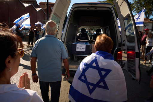 Mourners walk near the car carrying the coffin of slain hostage Guy Illouz during his funeral procession in Rishon Lezion, Israel, Wednesday, Oct. 15, 2025. Illouz remains were returned from Gaza to Israel as part of a ceasefire agreement between Israel and Hamas. (AP Photo/Emilio Morenatti) Mourners walk near the car carrying the coffin of slain hostage Guy Illouz during his funeral procession in Rishon Lezion, Israel, Wednesday, Oct. 15, 2025. Illouz remains were returned from Gaza to Israel as part of a ceasefire agreement between Israel and Hamas. (AP Photo/Emilio Morenatti)