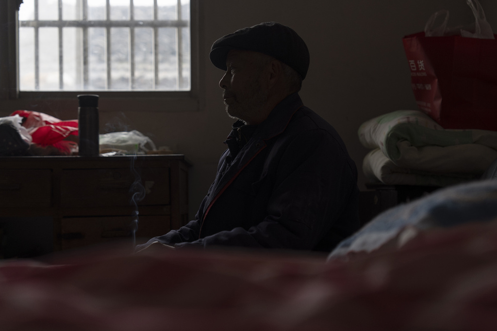 Petitioner Yang Guoliang, whose family has been trapped in an increasingly tight noose of surveillance for the past 16 years, rests in his bedroom at his home in Changzhou, in eastern China's Jiangsu Province, Friday, Dec. 13, 2024. (AP Photo/Ng Han Guan)