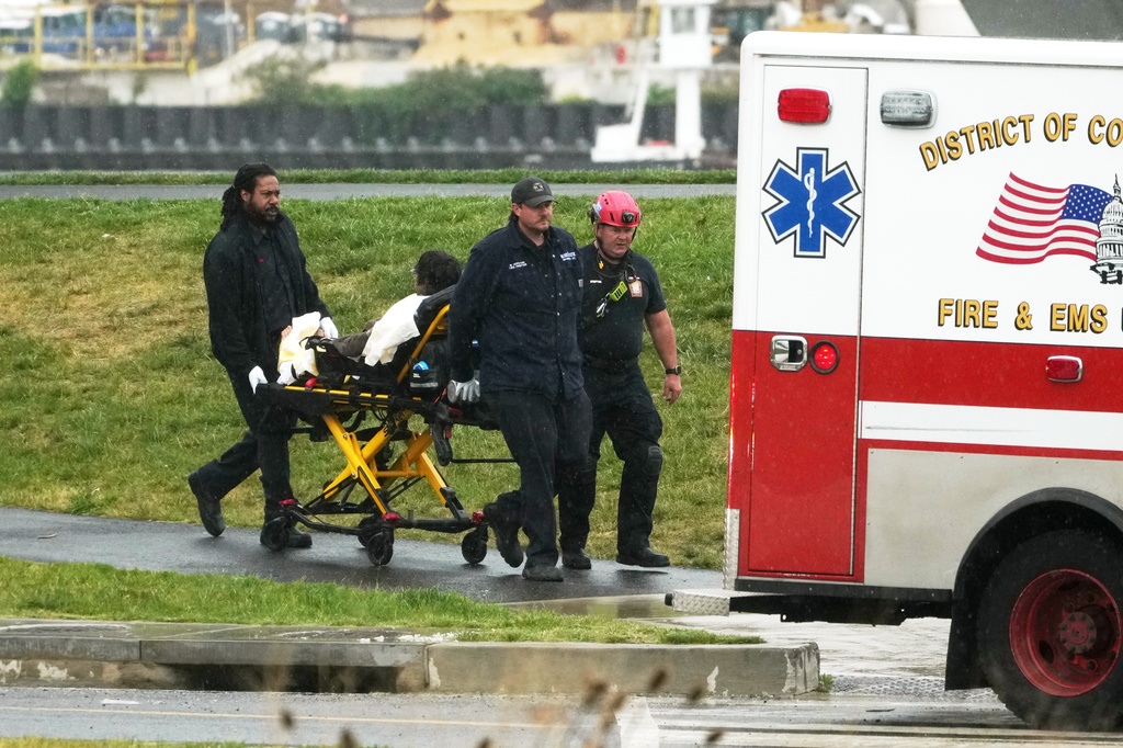 D.C. Fire and EMS, wheel Guido Reichstadter, 45, to an ambulance, Wednesday, May 6, 2026 in Washington. Reichstadter, who scaled to the top of the Frederick Douglass Bridge in Washington last week, has come down, after his 6-day protest. (AP Photo/Julia Demaree-Nikhinson)