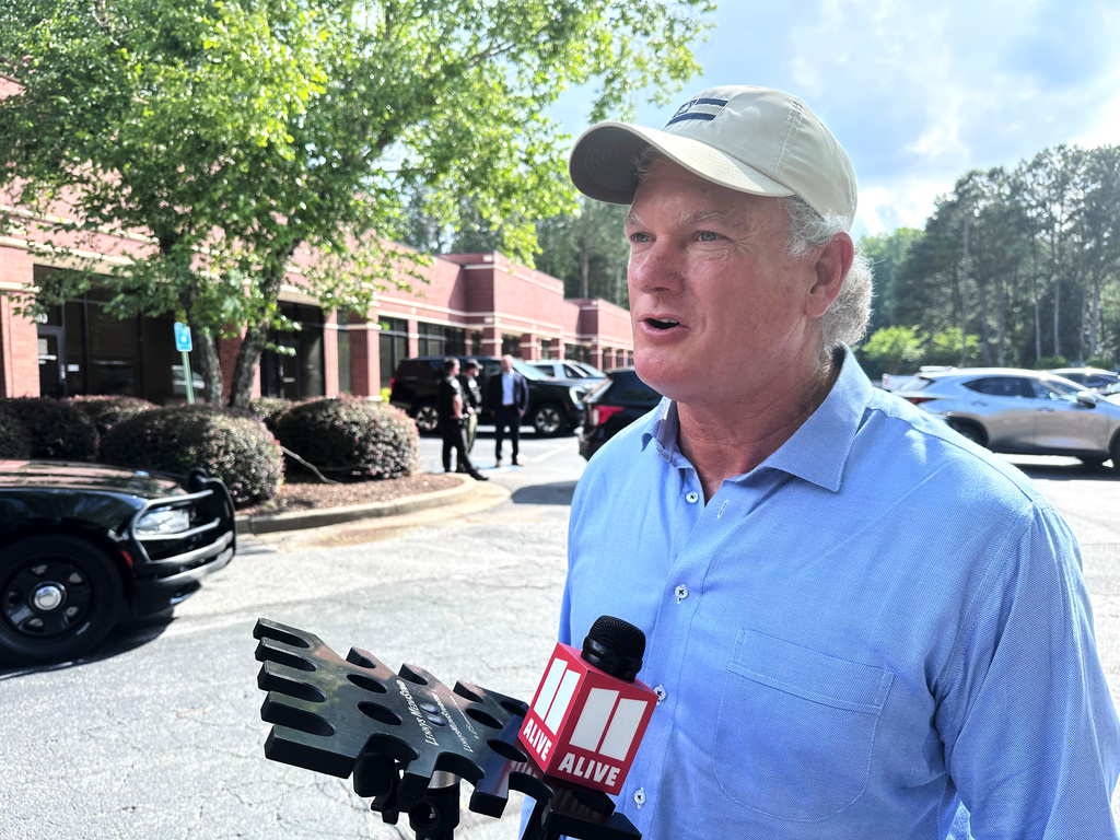 U.S. Rep Mike Collins campaigns in Woodstock, Ga., Sunday, June 14, 2026. ( AP Photo/Bill Barrow)