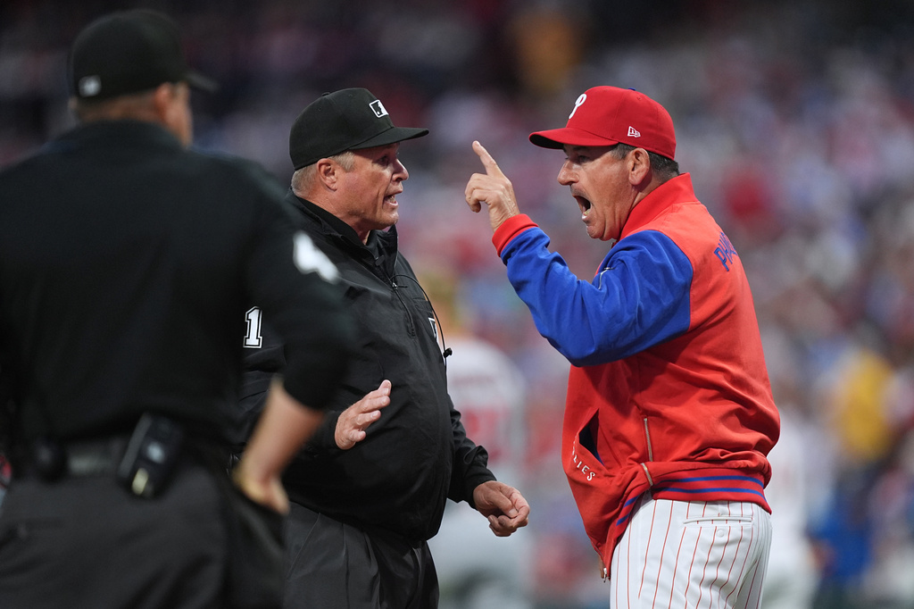 Philadelphia Phillies manager Rob Thomson speaks with an umpire during the first inning of a baseball game against the Washington Nationals, Monday, March 30, 2026, in Philadelphia. (AP Photo/Matt Rourke)