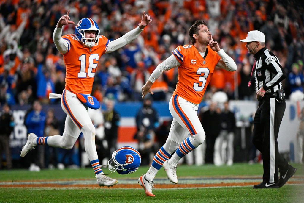 Denver Broncos place-kicker Wil Lutz (3) reacts with punter Jeremy Crawshaw (16) after making a field goal to win the game in overtime against the Seattle Seahawks in an NFL football game in Denver, Thursday, Oct. 15, 2026. (AP Photo/Geneva Heffernan)
