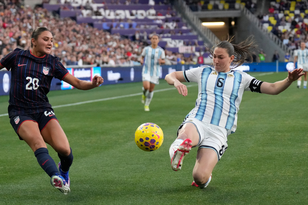 Argentina defender Aldana Cometti (6) deflects a ball kicked by United States defender Gisele Thompson (20) during the second half of a SheBelieves Cup women's soccer tournament match Sunday, March 1, 2026, in Nashville, Tenn. (AP Photo/George Walker IV)
