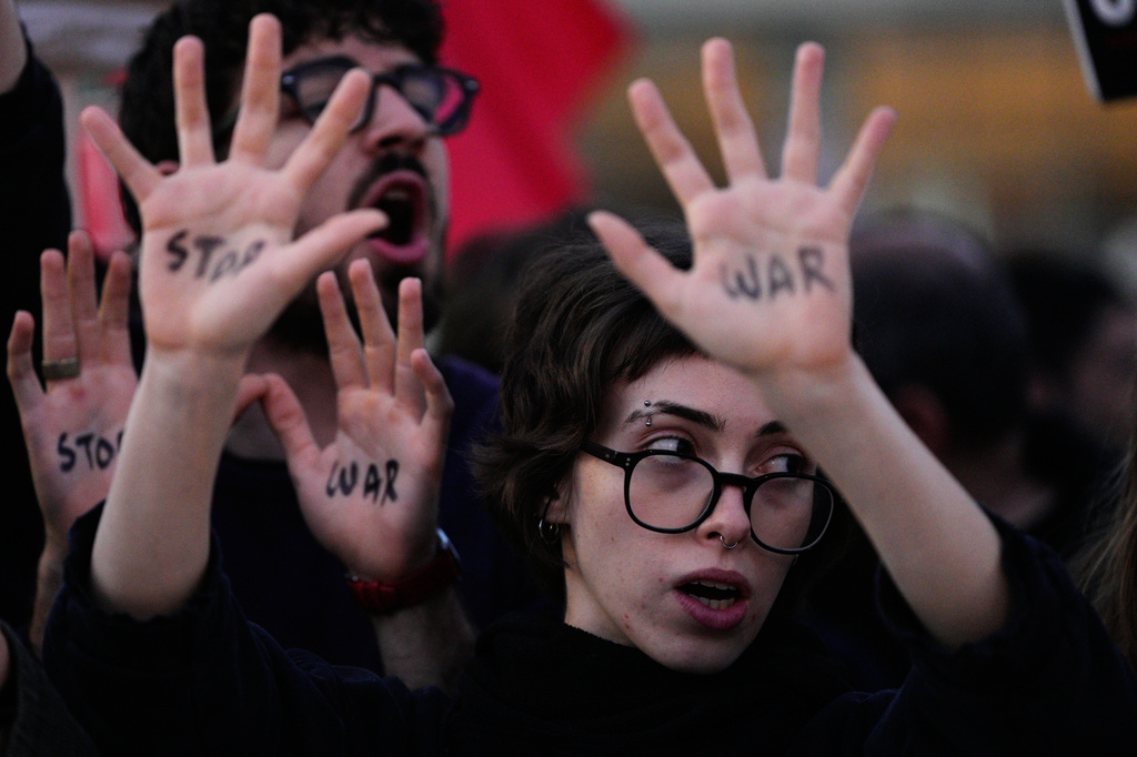 People raise their hands during a protest calling for an end to the war in Tel Aviv, Israel, Saturday, April 4, 2026. (AP Photo/Maya Levin)