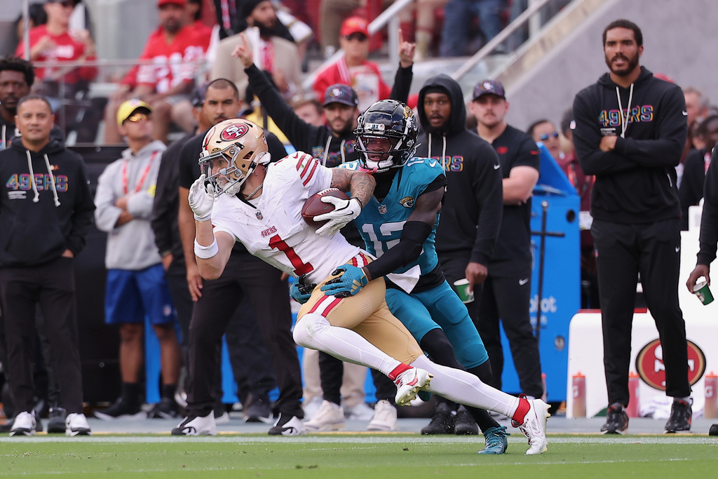 San Francisco 49ers wide receiver Ricky Pearsall (1) runs against Jacksonville Jaguars defensive back Travis Hunter during the first half ofan NFL football game in Santa Clara, Calif., Sunday, Sept. 28, 2025. (AP Photo/Kelley L. Cox)