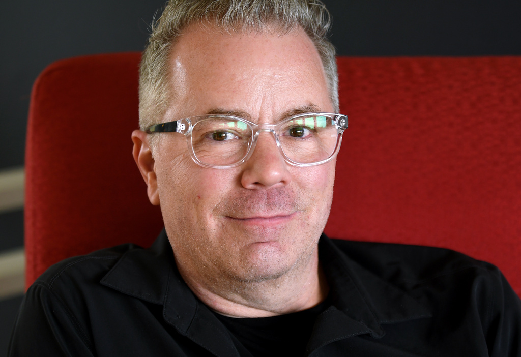 Tom Campbell, who is trying to visit as many replica Liberty Bells in the United States as possible, poses for a portrait at his home in Fort Collins, Colo., April 10, 2026. (AP Photo/Thomas Peipert)