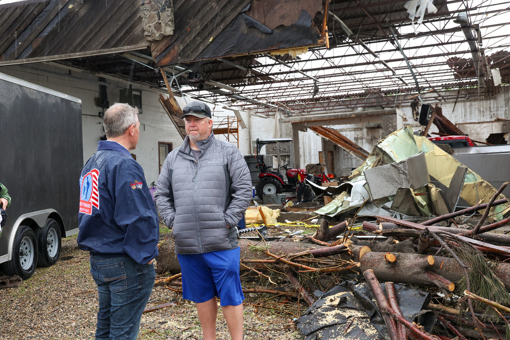 North Dakota Governor Kelly Armstrong speaks with homeowner Tyler Pfaff while surveying tornado damage on June 25, 2025, in Enderlin, N.D. (North Dakota Governor's Office via AP)