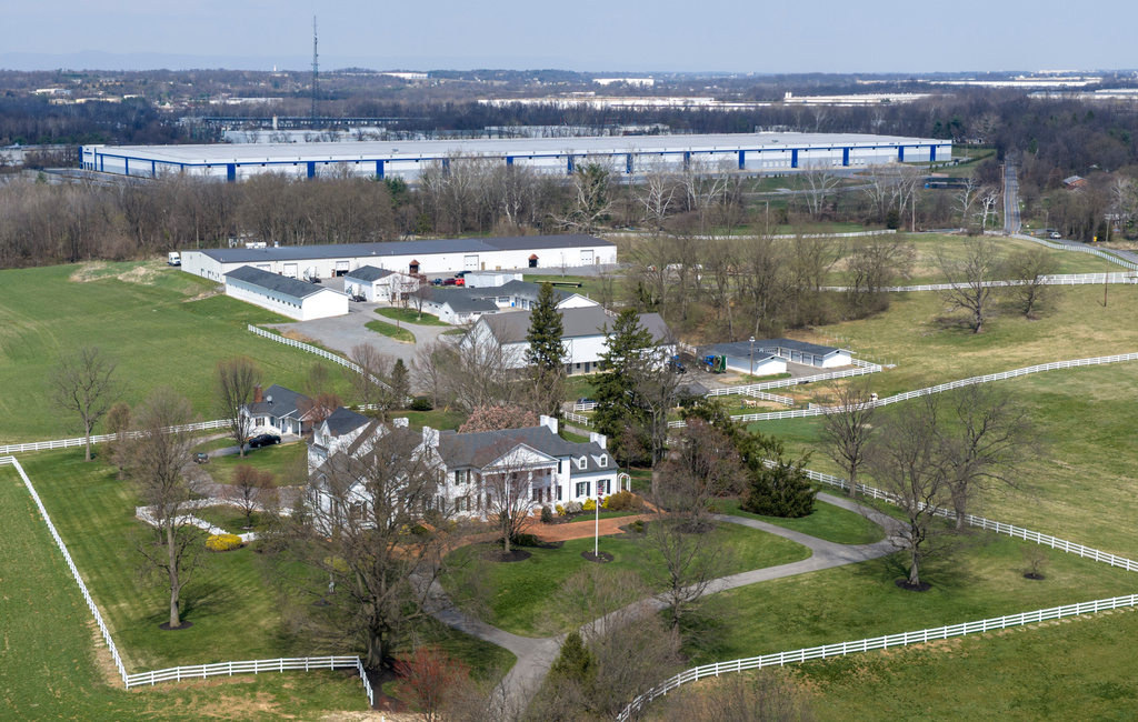 A stately southern mansion sits close to a proposed ICE detention center, top, in a small community in western Maryland known as a destination for weekend bicyclists and Civil War history buffs in Williamsport, Md., Thursday, March 26, 2026. (AP Photo/Steve Helber)