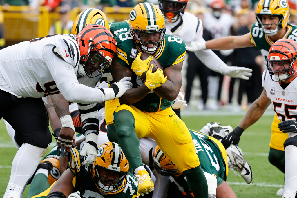 Green Bay Packers running back Josh Jacobs (8) scores a touchdown against the Cincinnati Bengals in the first half of an NFL football game, Sunday, Oct. 12, 2025, in Green Bay, Wis. (AP Photo/Mike Roemer)