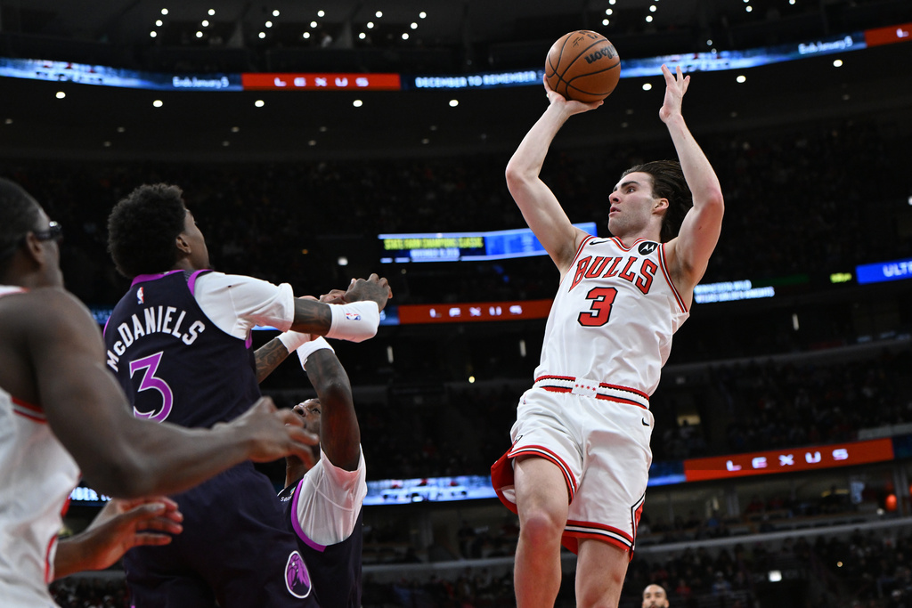 Chicago Bulls' Josh Giddey (3) goes up to shoot against Minnesota Timberwolves' Jaden McDaniels (3) during the first half of an NBA basketball game Monday, Dec. 29, 2025, in Chicago. (AP Photo/Paul Beaty)