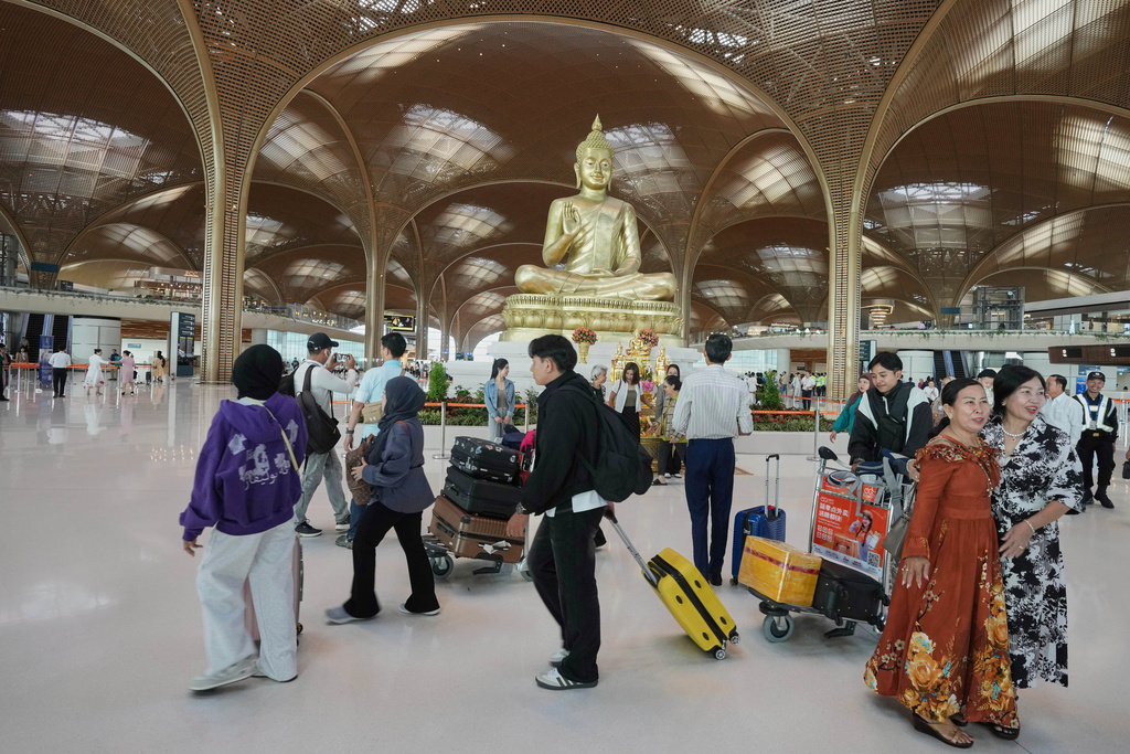 Tourists arrive to check in for their flights at the Techo International Airport on the outskirts of Phnom Penh, Cambodia, Tuesday, Sept. 9,2025. (AP Photo/Heng Sinith)