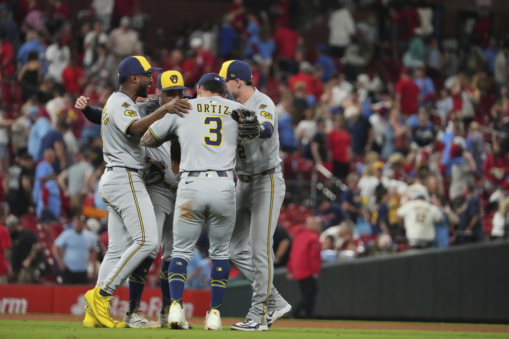 Members of the Milwaukee Brewers celebrate a victory over the St. Louis Cardinals following a baseball game Saturday, Sept. 20, 2025, in St. Louis. (AP Photo/Jeff Roberson)