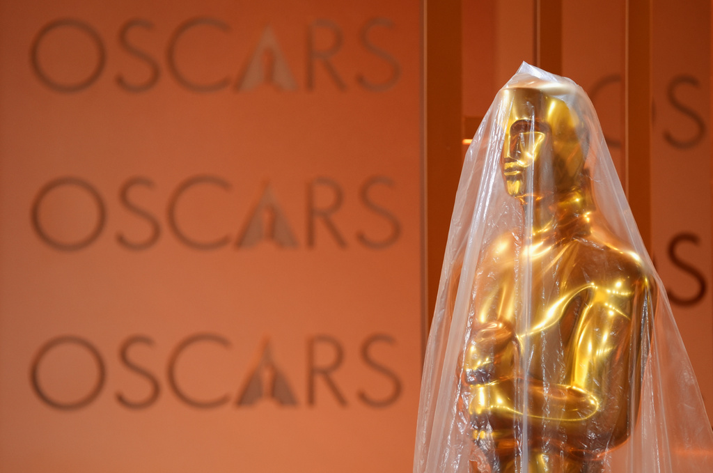 Oscar statue is protected by plastic in the red carpet area, Friday, March 13, 2026, at the Dolby Theatre in Los Angeles in preparation for Sunday's 98th Academy Awards ceremony. (AP Photo/Chris Pizzello)