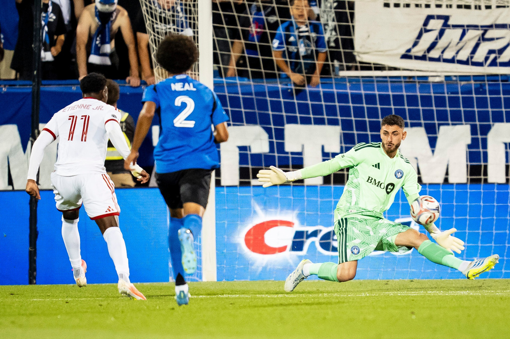 CF Montreal goalkeeper Thomas Gillier (31) makes a save on Toronto FC's Derrick Etienne Jr. (11) while CF Montreal's Jalen Neal (2) defends during the second half of an MLS soccer game, in Montreal on Thursday, July 16, 2026. (Christopher Katsarov/The Canadian Press via AP)