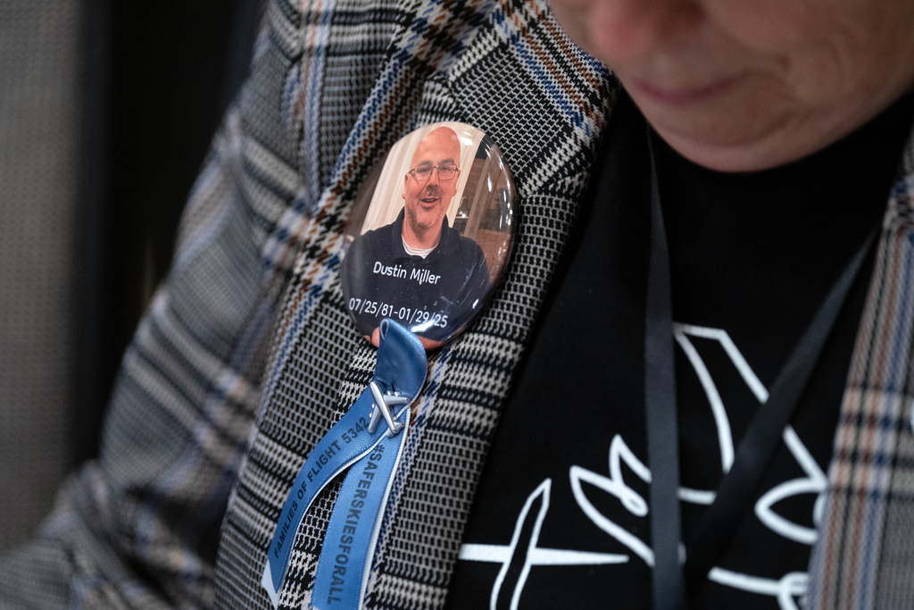 People attend the National Transportation Safety Board (NTSB) hearing on the midair aircraft collision that killed 67 people near Washington Reagan National Airport, at the National Transportation and Safety Board boardroom in Washington, Tuesday, Jan. 27, 2026. (AP Photo/Jose Luis Magana)