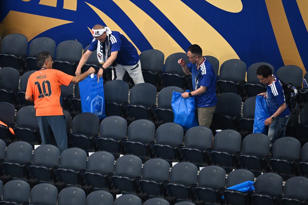 Japan fans clean up trash in the stadium following the World Cup Group F soccer match between the Netherlands and Japan in Arlington, Texas, near Dallas, Sunday, June 14, 2026. (AP Photo/Jessica Tobias)