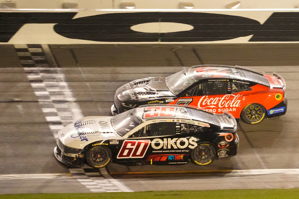 Ryan Preece (60) crosses the finish line ahead of Daniel Suarez (7) to win a NASCAR Cup Series auto race at Daytona International Speedway, Saturday, Aug. 29, 2026, in Daytona Beach, Fla. (AP Photo/John Raoux)