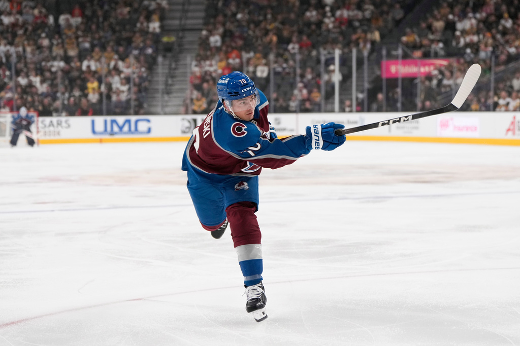 Colorado Avalanche defenseman Sam Malinski shoots against the Vegas Golden Knights during the first period of an NHL hockey game Friday, Oct. 31, 2025, in Las Vegas. (AP Photo/Lucas Peltier)