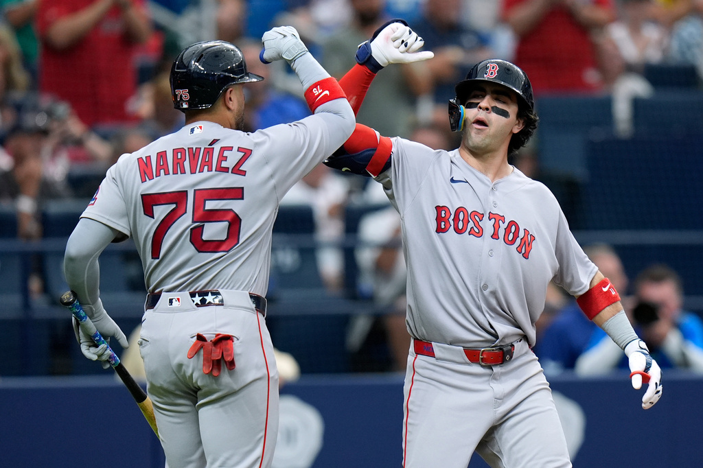 Boston Red Sox's Marcelo Mayer celebrates his solo home run off Tampa Bay Rays pitcher Ian Seymour with Carlos Narváez (75) during the third inning of a baseball game Monday, June 8, 2026, in St. Petersburg, Fla. (AP Photo/Chris O'Meara)