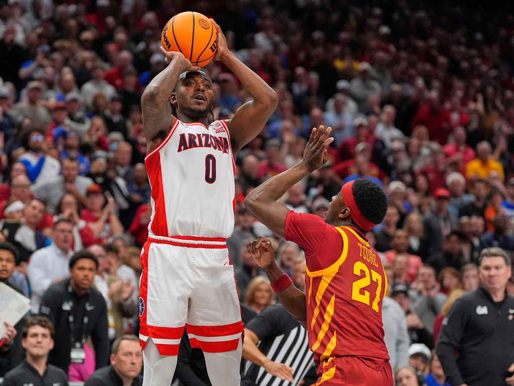 Arizona's Jaden Bradley (0) makes a game-winning basket over Iowa State's Killyan Toure at the buzzer to defeat Iowa State during an NCAA college basketball game in the semifinal round of the Big 12 Conference tournament Friday, March 13, 2026, in Kansas City, Mo. (AP Photo/Charlie Riedel)