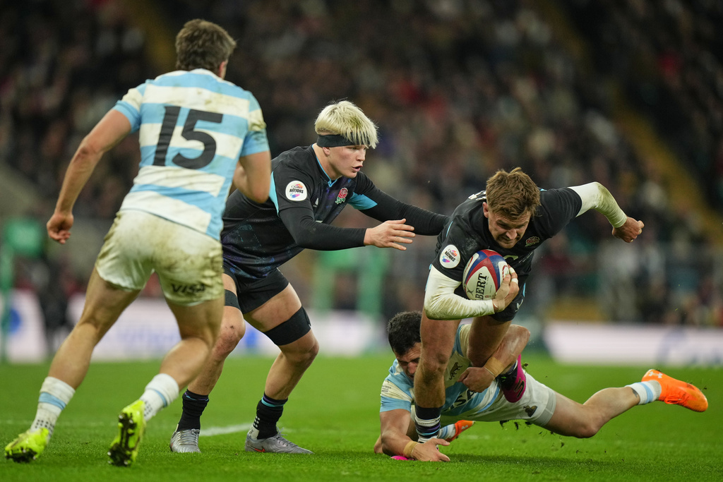 England's Henry Slade is tackled by Argentina's Matias Moroni during the Nation's Series rugby union international between England and Argentina at Twickenham, London, Sunday, Nov. 23, 2025. (AP Photo/Alastair Grant)