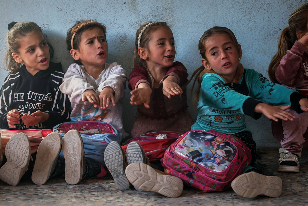Students take part in an activity inside a classroom of the Maar Shmarin Primary School in the village of Maar Shmarin, in the Idlib countryside, Syria, Sunday, Oct. 19, 2025. (AP Photo/Ghaith Alsayed)