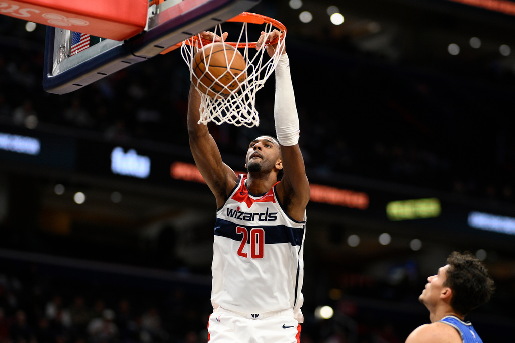 Washington Wizards center Alex Sarr (20) dunks during the first half of an NBA basketball game against the Orlando Magic, Tuesday, Jan. 6, 2026, in Washington. (AP Photo/Nick Wass)