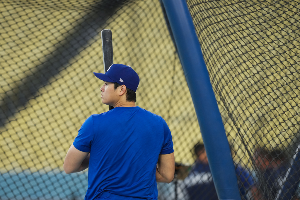 Los Angeles Dodgers' Shohei Ohtani enters the batting cage during a workout ahead of Game 3 of baseball's National League Championship Series against the Milwaukee Brewers, Tuesday, Oct. 13, 2026, in Los Angeles. (AP Photo/Jae C. Hong)