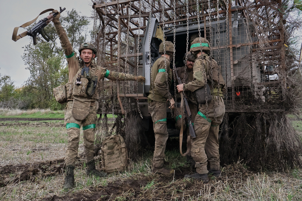 In this photo provided by Ukraine's 65th Mechanized Brigade press service, soldiers react as they came back after a long time mission on the frontline in the Zaporizhzhia region, Ukraine, Monday, Oct. 19, 2026. (Andriy Andriyenko/Ukraine's 65th Mechanized Brigade via AP)