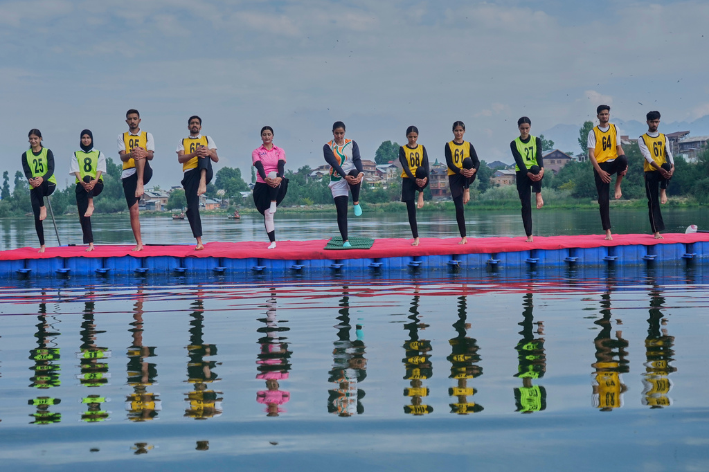 Participants perform yoga during an International Yoga Day event at Pokhrabal Lake in Srinagar, Indian controlled Kashmir, Sunday, June 21, 2026. (AP Photo/Mukhtar Khan)