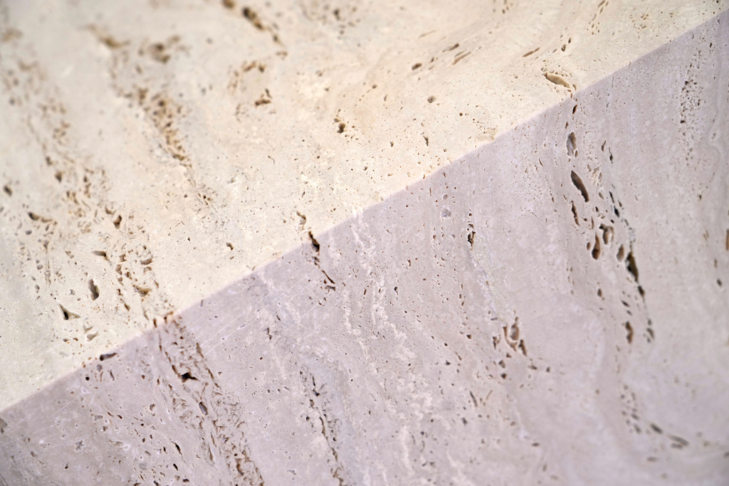 Light reverberates on a travertine block at the Mariotti Carlo SpA stonecutting firm in Tivoli, Italy, on Friday, Feb. 13, 2026; the block will be used to adorn the tower of the new Manhattan temple in New York City. (AP Photo/Gregorio Borgia)