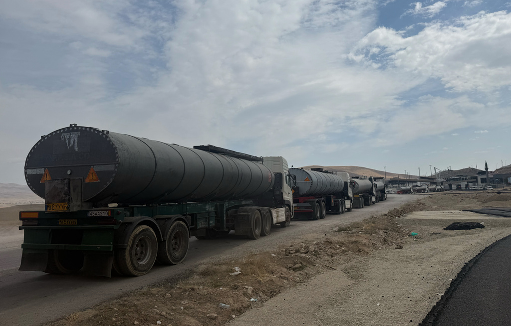 Trucks queue on the road leading to the Gurbulak border crossing on the Turkish-Iranian border in Agri province, eastern Turkey, Tuesday, Sept. 22, 2026. (AP Photo/Serra Yedikardes)