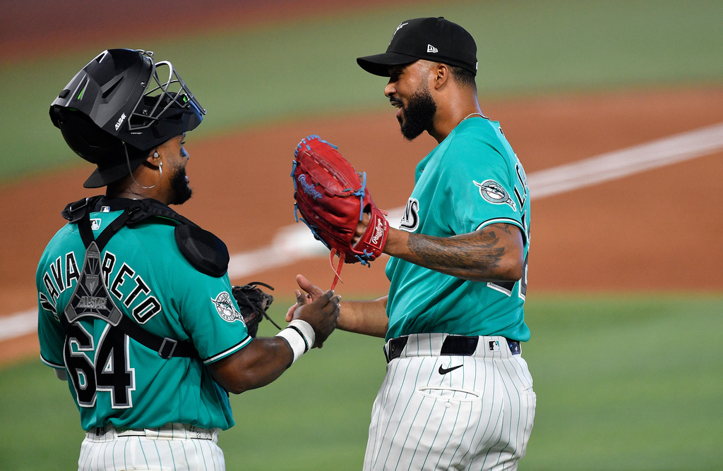 Miami Marlins Sandy Alcantara, right, celebrates beating the Atlanta Braves with catcher Brian Navarreto after the ninth inning of a baseball game, Sunday, Sept. 27, 2026, in Miami. (AP Photo/Michael Laughlin)