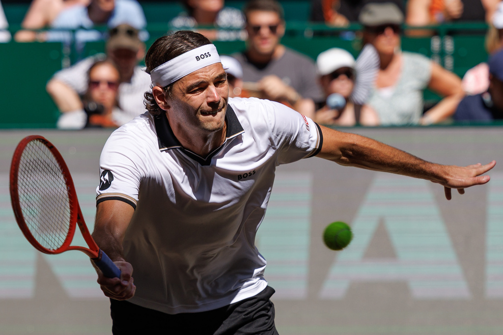 United States' Taylor Fritz returns the ball to United States' Frances Tiafoe during their final match at the ATP Germany Open tennis tournament in Halle, Germany, Sunday, June 21, 2026. (Friso Gentsch/dpa via AP)