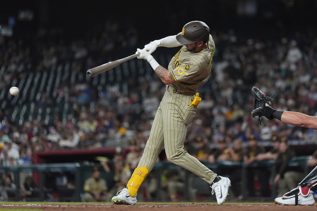 San Diego Padres' Jackson Merrill connects for an infield single against the Arizona Diamondbacks during the second inning of a baseball game, Monday, Aug. 3, 2026, in Phoenix. (AP Photo/Ross D. Franklin)