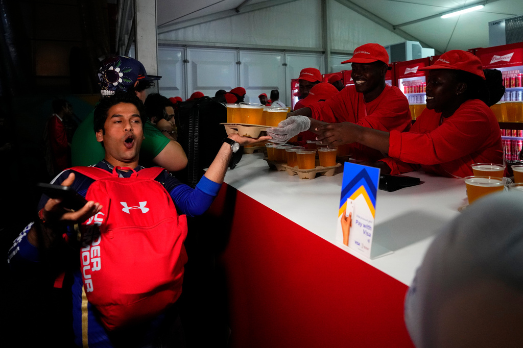 FILE - A man buys beers at a fan zone ahead of the FIFA World Cup, in Doha, Qatar, Nov. 19, 2022. (AP Photo/Petr Josek, File)