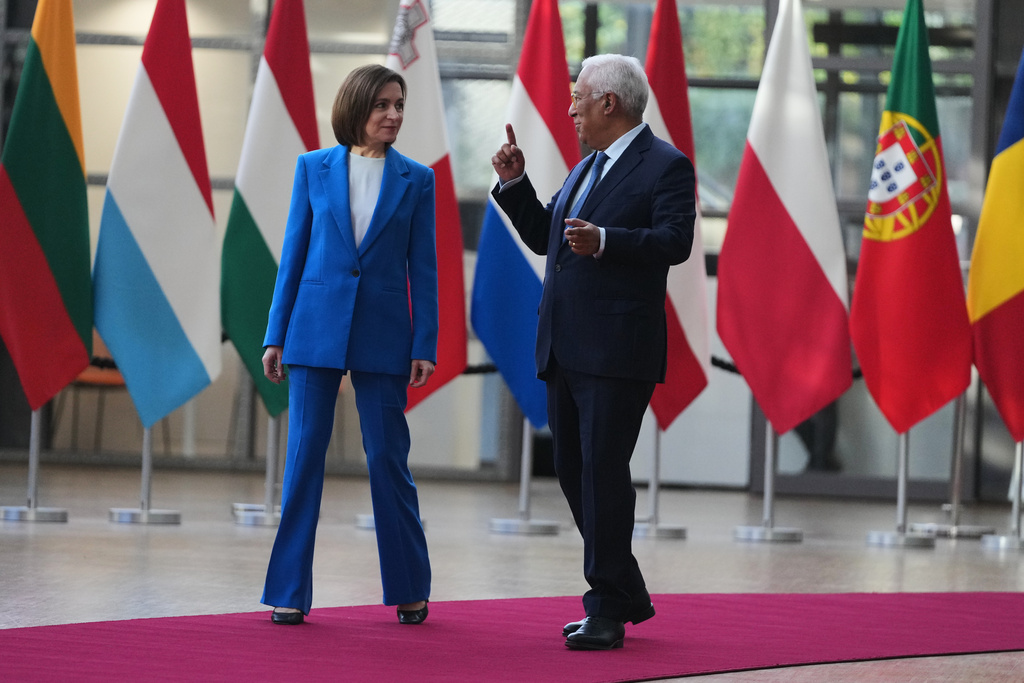 European Council President Antonio Costa, right, walks with Moldova's President Maia Sandu prior to a meeting at the European Council building in Brussels, Belgium, Tuesday, Nov. 4, 2025. (AP Photo/Virginia Mayo)