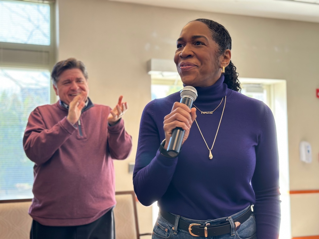 Joined by Illinois Gov. JB Pritzker, left, Lt. Gov. Juliana Stratton, who is running for an open U.S. Senate seat, speaks to residents at the Montclare Senior Residences of Avalon Park in Chicago, Thursday, March 12, 2026. (AP Photo/Sophia Tareen)