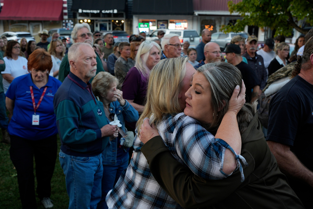 Christina Williams, right, hugs Tracy Cook during a candlelight vigil honoring the victims of a blast at an explosives plant, Accurate Energetic Systems, Sunday, Oct. 12, 2025, in Waverly, Tenn. (AP Photo/George Walker IV)