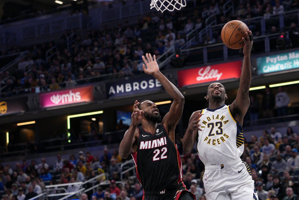 Indiana Pacers guard Aaron Nesmith (23) looks to shoot in front of Miami Heat forward Andrew Wiggins (22) during the first half of an NBA basketball game in Indianapolis, Saturday, Jan. 10, 2026. (AP Photo/AJ Mast)