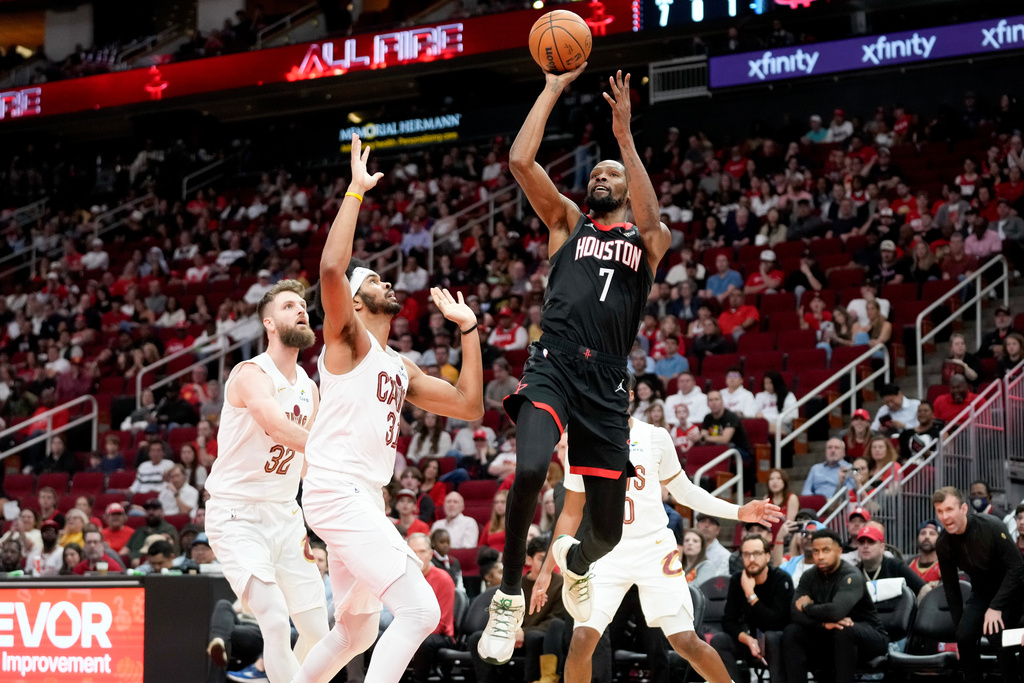 Houston Rockets forward Kevin Durant (7) shoots as Cleveland Cavaliers center Jarrett Allen, left, defends during the first half of an NBA basketball game Saturday, Dec. 27, 2025, in Houston. (AP Photo/Eric Christian Smith)